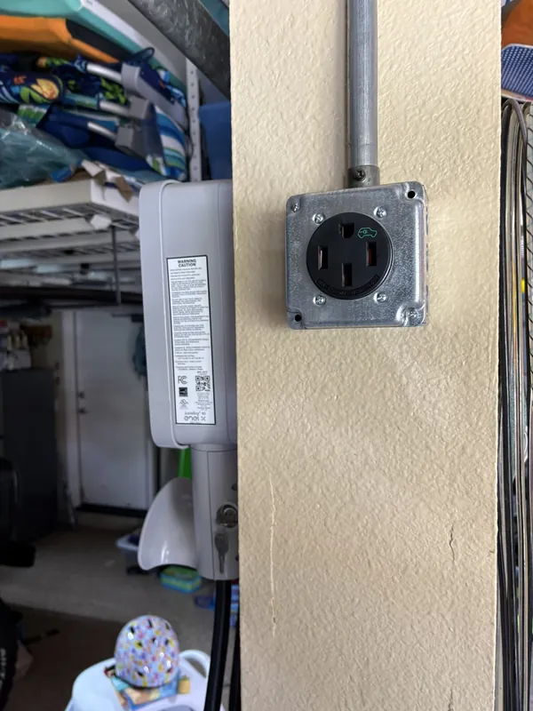 240V EV charging outlet run in conduit in a garage