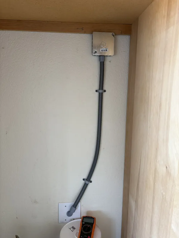 Outlet wiring added inside a built-in cabinet