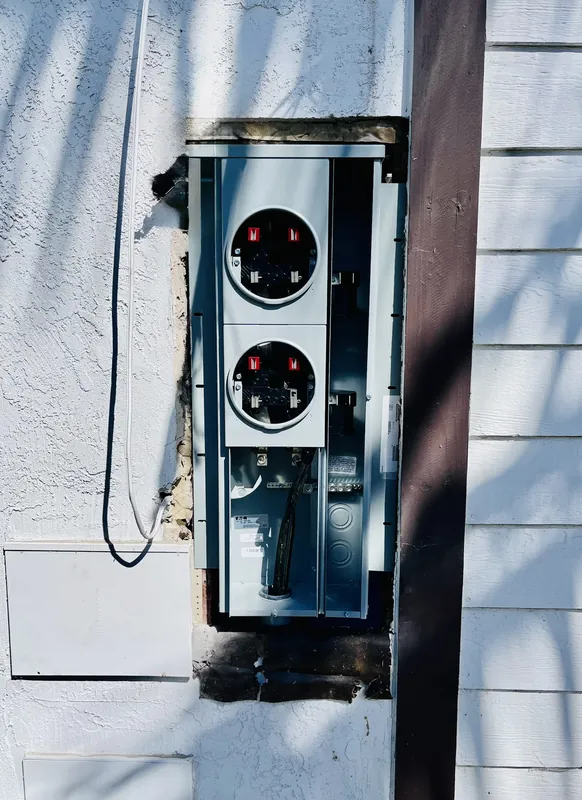 Dual meter panel installation on a home exterior