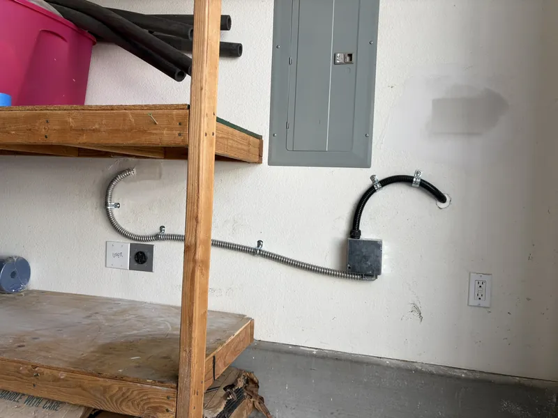 New EV circuit run in conduit along a garage wall