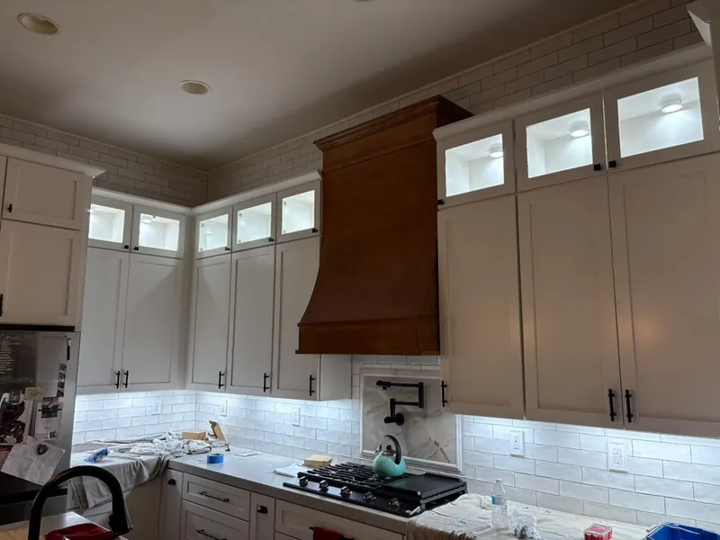 Kitchen with new under-cabinet LED lighting and lit glass-front upper cabinets