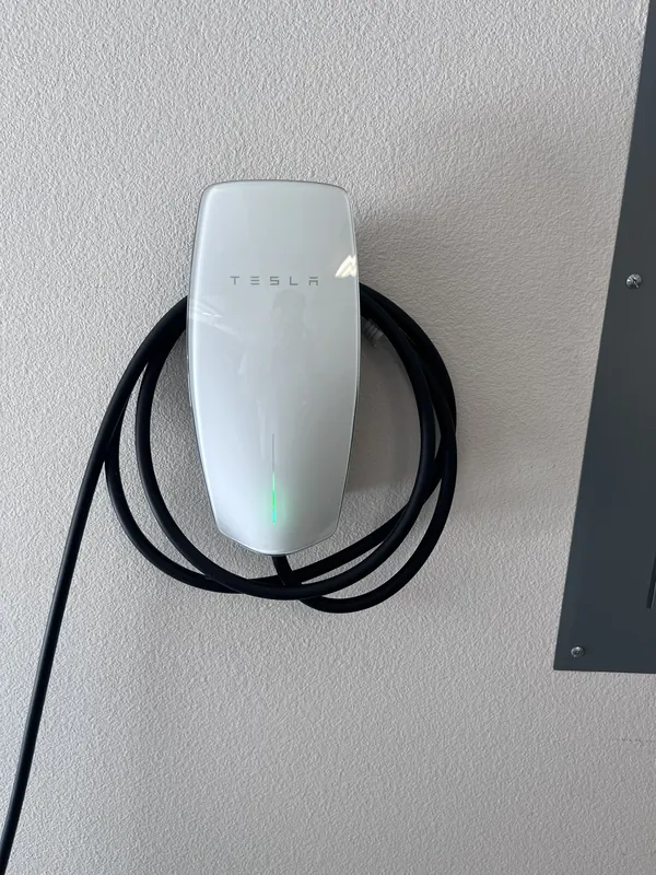 Tesla Wall Connector installed on a garage wall